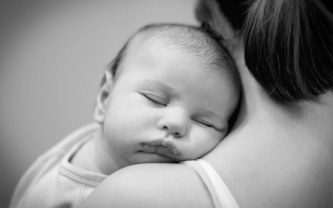Baby sleeping on Mother's Shoulder